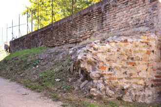 nuove murature a fianco di Porta Serrata e avanzi del ponte sul Padenna costruito in materiale lapideo