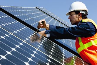 Worker Repairing Solar Power Panel