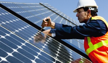 Worker Repairing Solar Power Panel