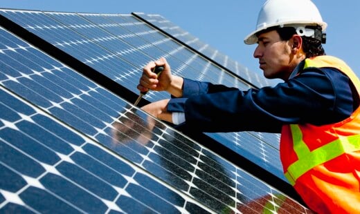 Worker Repairing Solar Power Panel
