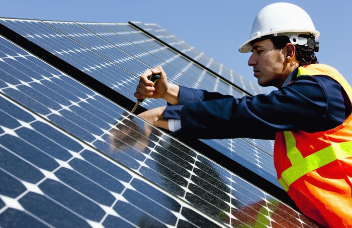 Worker Repairing Solar Power Panel