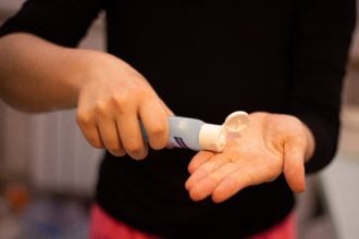 Person In Black Shirt Holding White Plastic Tube 3974140