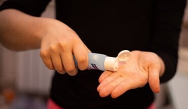 Person In Black Shirt Holding White Plastic Tube 3974140