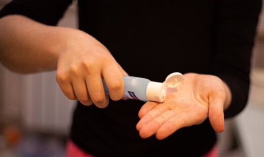 Person In Black Shirt Holding White Plastic Tube 3974140