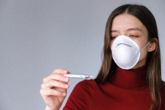 Woman In Face Mask Checking Thermometer 3987152