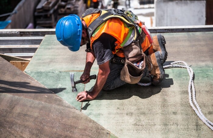 Man Wearing Blue Hard Hat Using Hammer 544966
