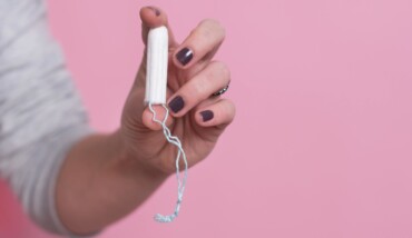 Woman's Hand Holding A Clean Cotton Tampon