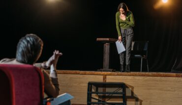 Selective Focus Of Theater Director And Bowing Actress On Stage