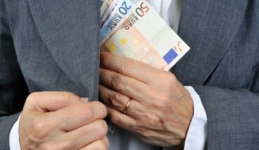 Man Putting Money In His Pocket 